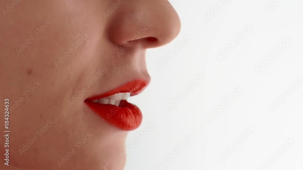 Beautiful woman with white smile painting sexy lips by lipstick red color Beautiful woman with white smile painting sexy lips by lipstick red color