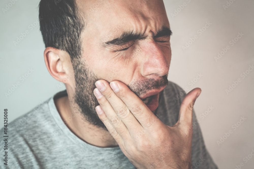 Fototapeta premium Caucasian man suffering toothache.