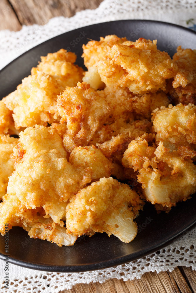 fried cauliflower in breading close-up. vertical fried cauliflower in breading close-up. vertical