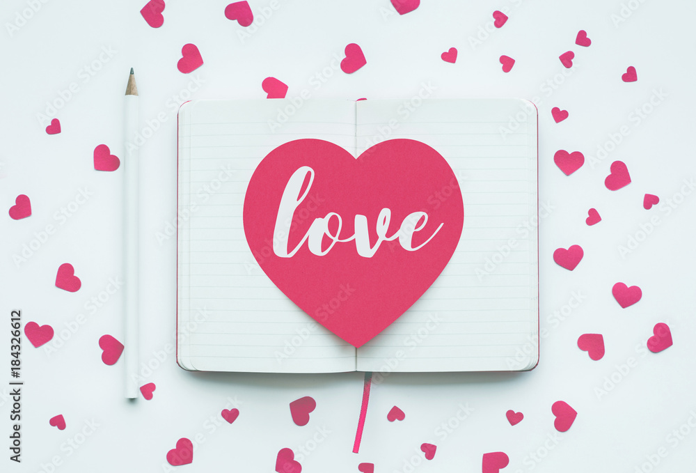 Love message on pink heart shape on white notepad background..valentine,wedding concepts