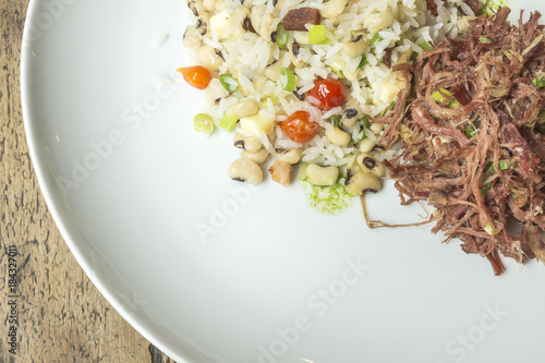 Typical brazilian food the name baiao de dois, is rice with beans together and dried meat photo