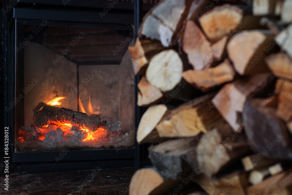 Fireplace with stack of firewoods