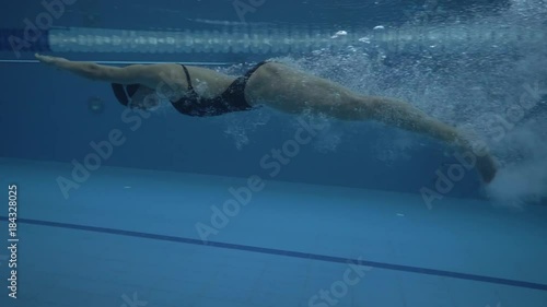 Woman jumping in transparentwater on floating poolunder water view 60 fps