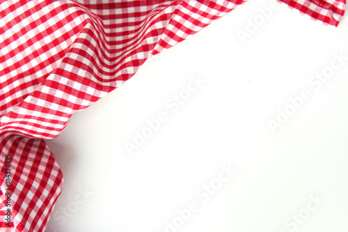 Red checkere clothes on white table empty space background.