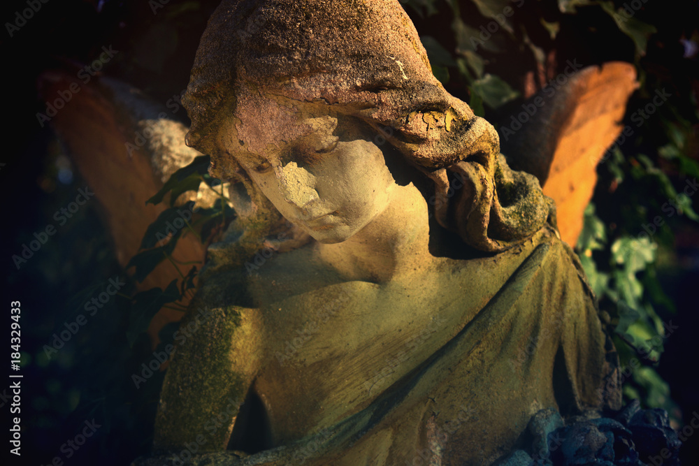 Fototapeta premium Majestic view of statue of golden angel illuminated by sunlight