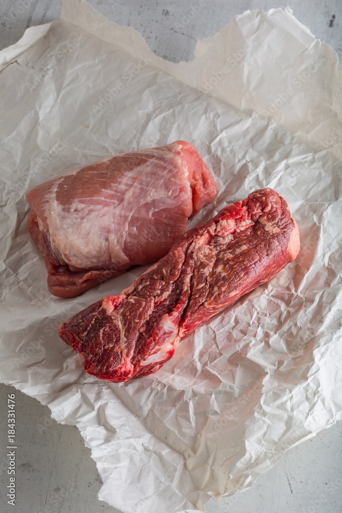 Beef and pork meat on white concrete background