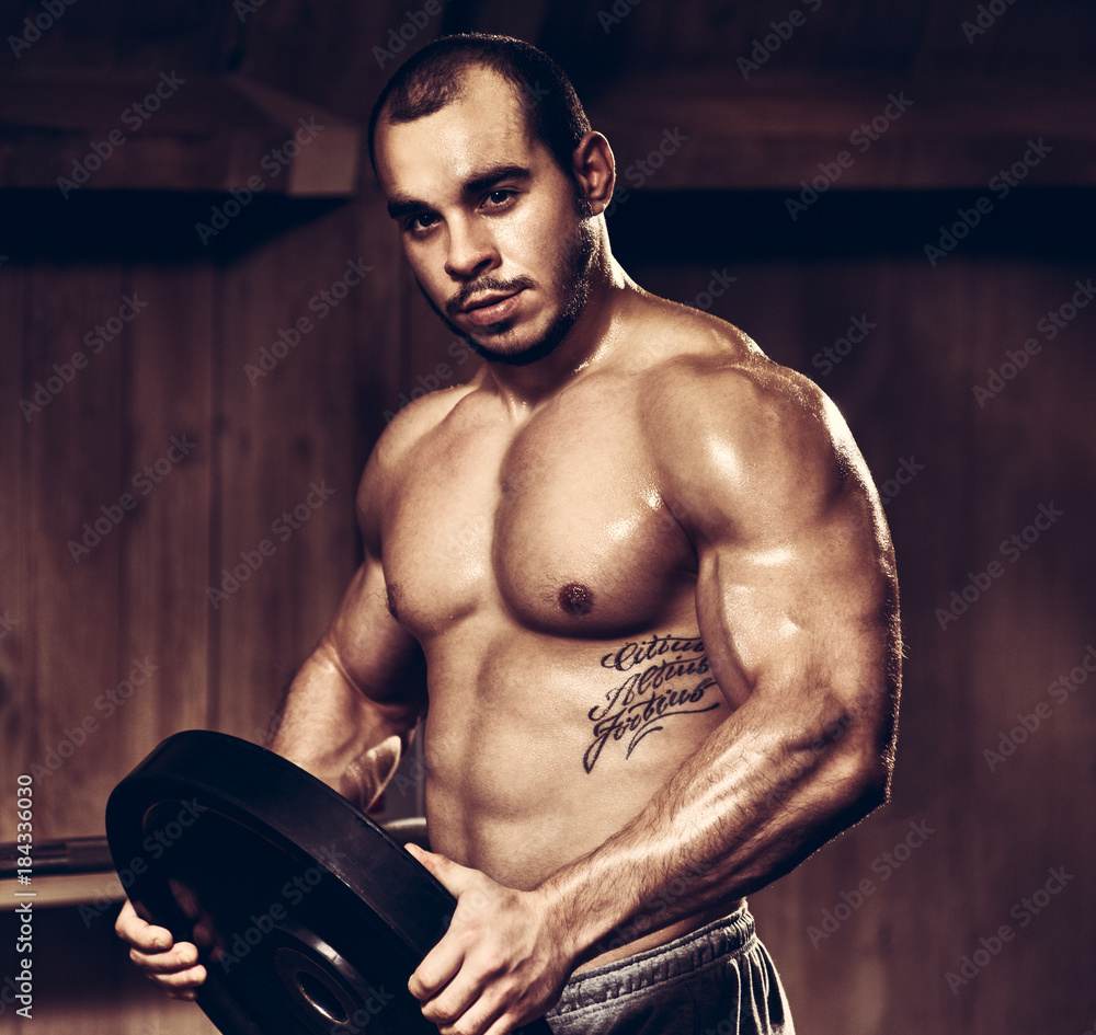 Fototapeta premium Athlete with weightlifting plate