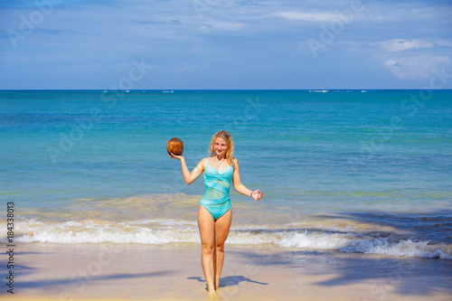 Girl with coco on the beach