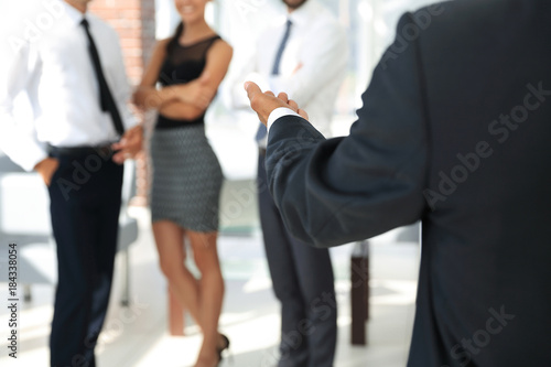 rear view.closeup. businessman holding out hand for a handshake.