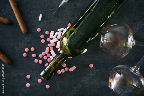 Composition with alcohol and drugs on grey background. Concept of bad habits