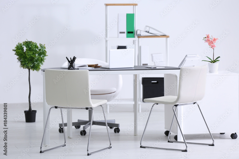 Fototapeta premium Modern office interior with table and white chairs