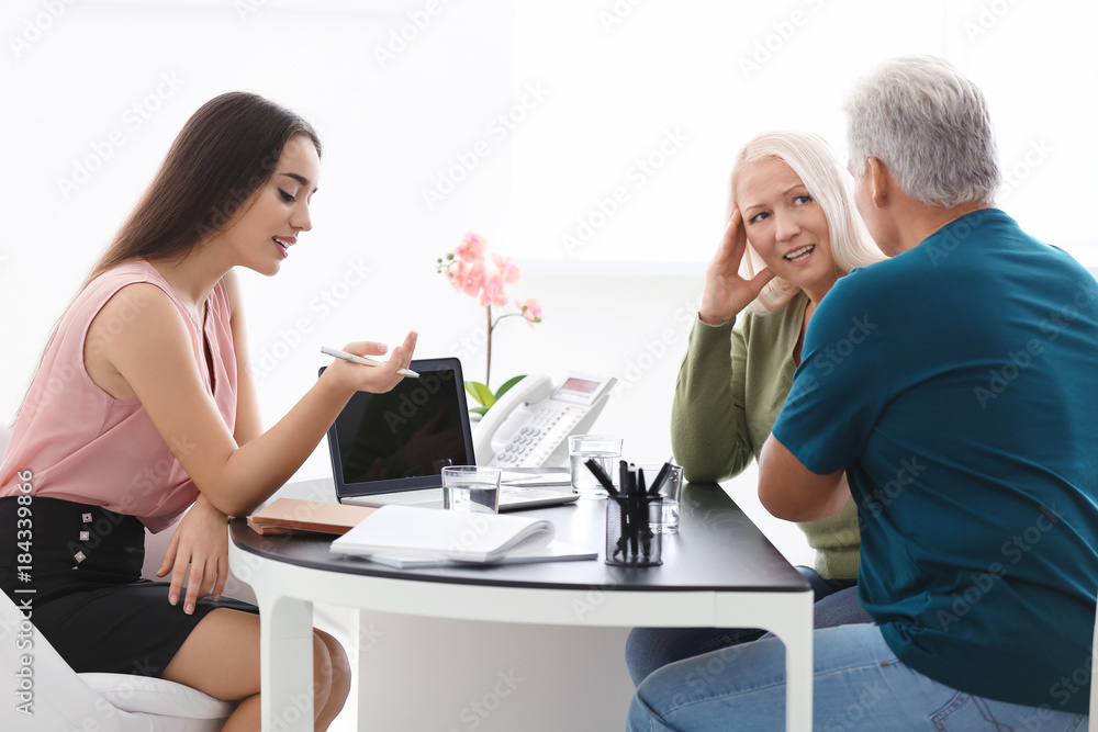 Senior couple meeting with consultant in office Senior couple meeting with consultant in office