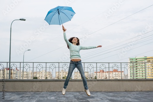 The girl is flying with an umbrella