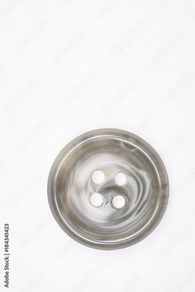 Sewing buttons on white background close up Sewing buttons on white background close up