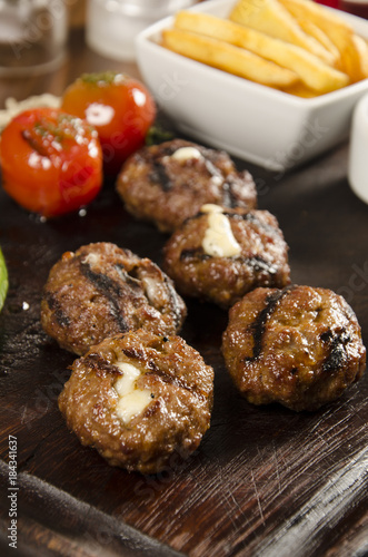 grilled meatballs with melted cheddar cheese