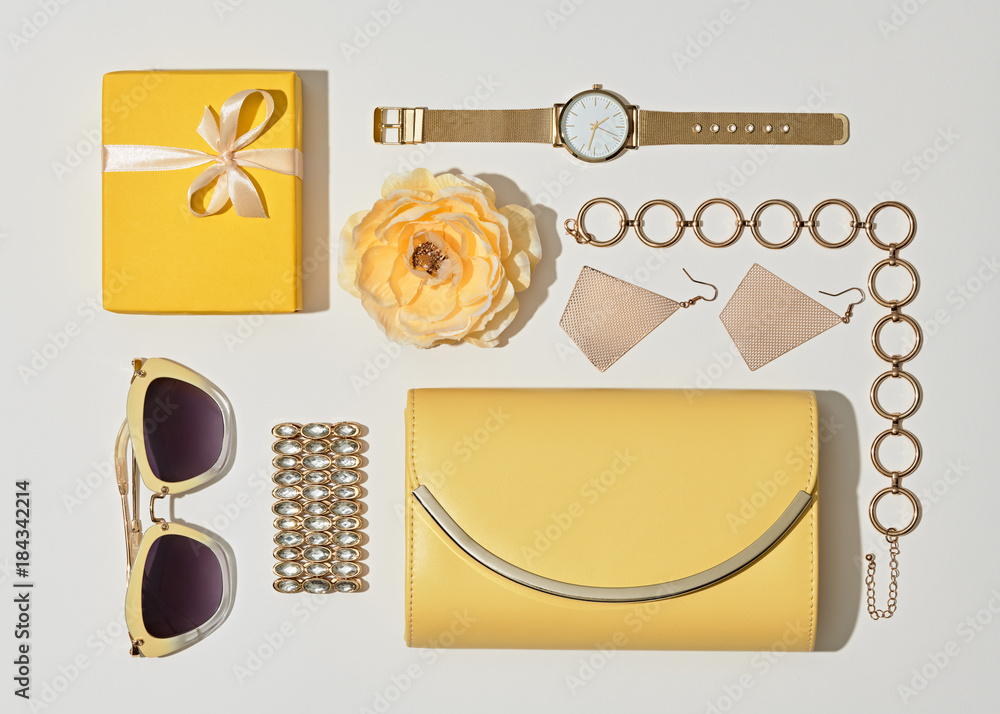Fashion. Woman Accessories Set. Flat lay. Trendy Gold Watch, Summer Sunglasses, Glamour fashion Yellow Clutch. Flower. Luxury Stylish Spring lady. Pastel Color Fashion. Woman Accessories Set. Flat lay. Trendy Gold Watch, Summer Sunglasses, Glamour fashion Yellow Clutch. Flower. Luxury Stylish Spring lady. Pastel Color