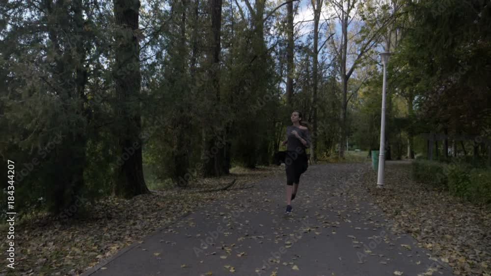 Attractive manager woman with toned body running in the park after work to clear her mind and get rid of stress in slow motion Attractive manager woman with toned body running in the park after work to clear her mind and get rid of stress in slow motion
