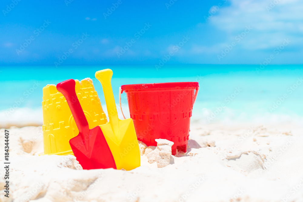 Kid's beach toys on white sandy beach Kid's beach toys on white sandy beach
