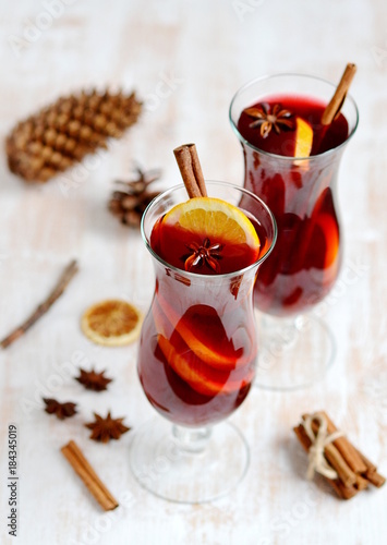 Two Glass of Hot Red Wine Wooden Background Cone Cinnamon Orange Winter Decor 
