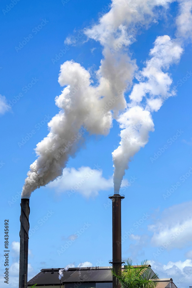 Smoking chimneys of Tully Sugar Mill in Queensland Australia Smoking chimneys of Tully Sugar Mill in Queensland Australia