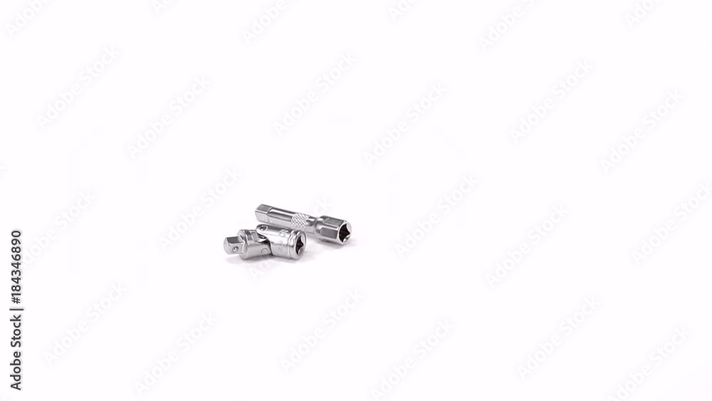 universal joint and small socket wrench are lying on a white background and rotating universal joint and small socket wrench are lying on a white background and rotating