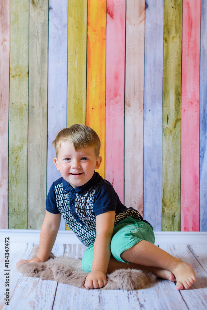 Fototapeta premium Portrait of happy and smiling child boy with blue eyes in her living room