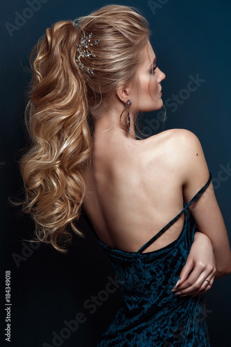 Model blonde Woman with perfect hairstyle and creative hair-dress, back view