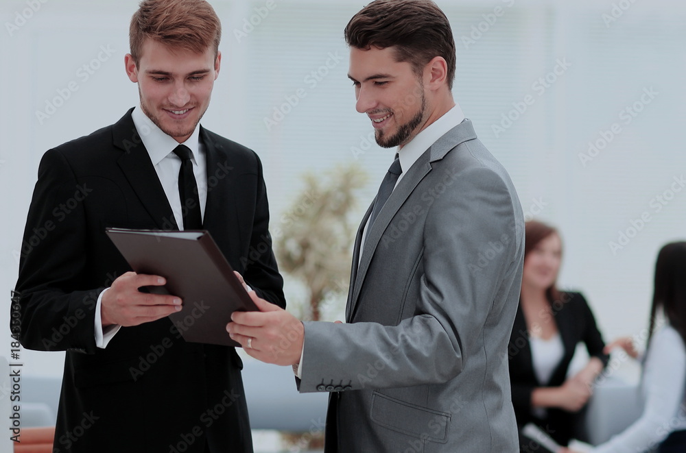 Two successful business partners discussing documents and ideas Two successful business partners discussing documents and ideas