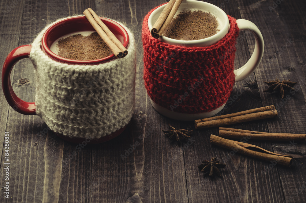 Traditional winter eggnog in decorative mugs with cinnamon/Traditional winter eggnog in decorative mugs with cinnamon on a dark background Traditional winter eggnog in decorative mugs with cinnamon/Traditional winter eggnog in decorative mugs with cinnamon on a dark background