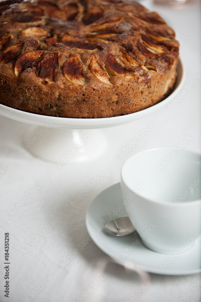 Fresh homemade apple cake on a laid table with white table cloth Fresh homemade apple cake on a laid table with white table cloth