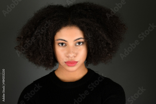 Young black woman with afro hairstyle. 