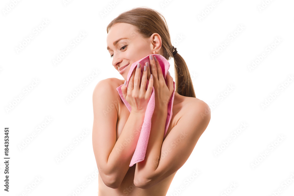 Beautiful young woman beauty face wiping her face with a towel spa cosmetology Beautiful young woman beauty face wiping her face with a towel spa cosmetology