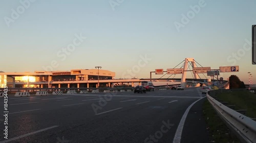 The highway to the international Airport of Milan Malpensa, full of traffic in sunset. This highway goes to terminal 1, to arrivals or departures for international flight or trips. photo