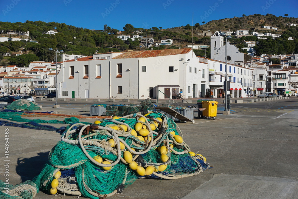 Spain Costa Brava Mediterranean village El Port de la Selva with fishing net in foreground, Alt Emporda, Catalonia
