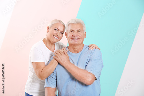 Mature couple against color...