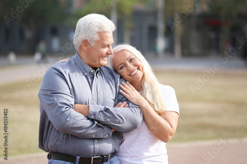 Mature couple walking together outdoors © Africa Studio