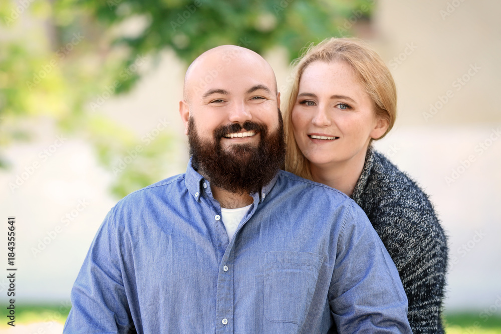 Romantic overweight couple in park