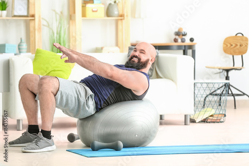 Overweight man doing exerci...