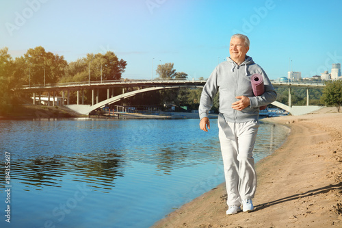 Mature man with mat walking...