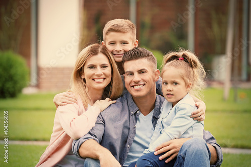 Happy family in courtyard n...