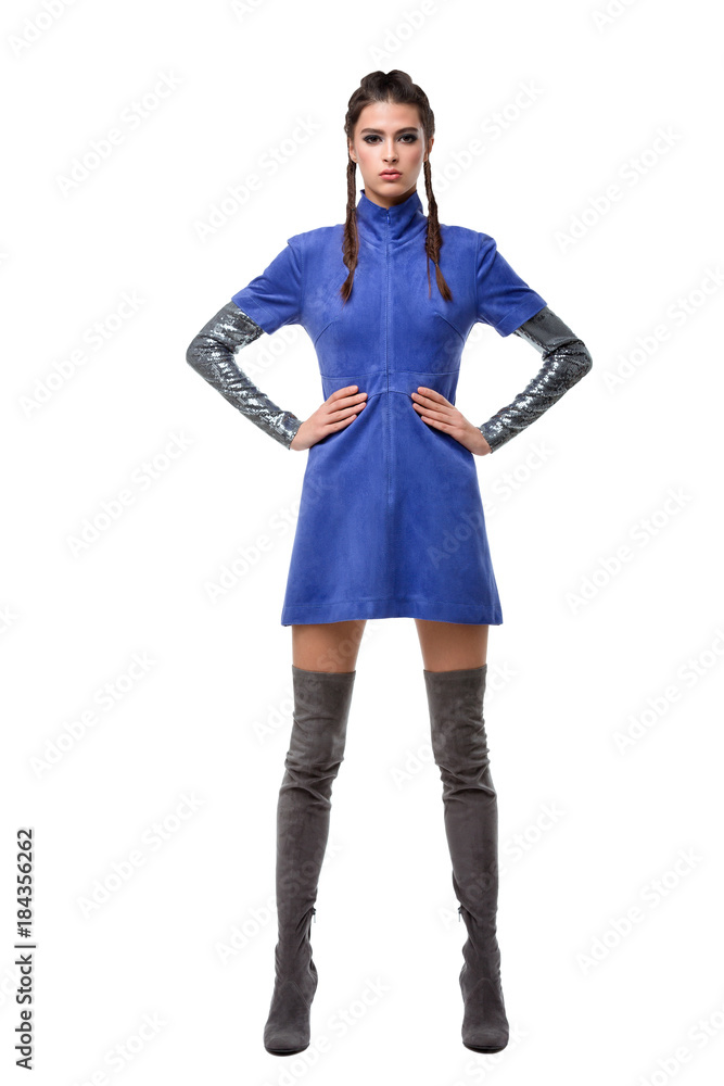 Young beautiful lady standing in blue dress and knee high boots on white background Young beautiful lady standing in blue dress and knee high boots on white background