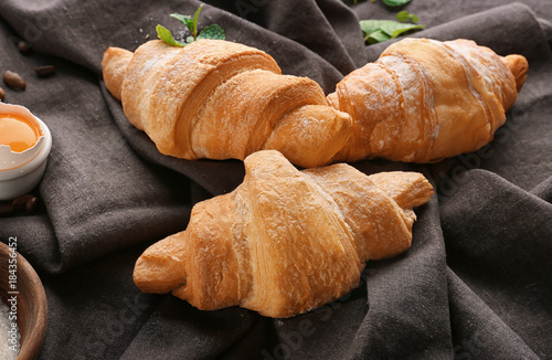 Tasty sweet croissants on table