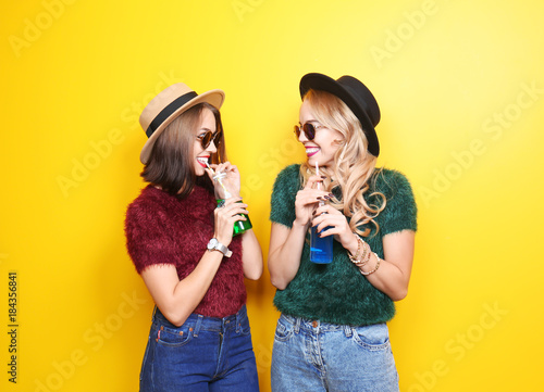 Two happy hipster girls wit...
