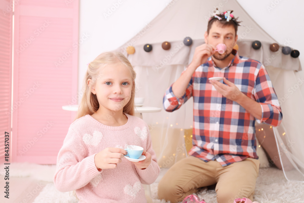 Cute little girl playing with father at home Cute little girl playing with father at home