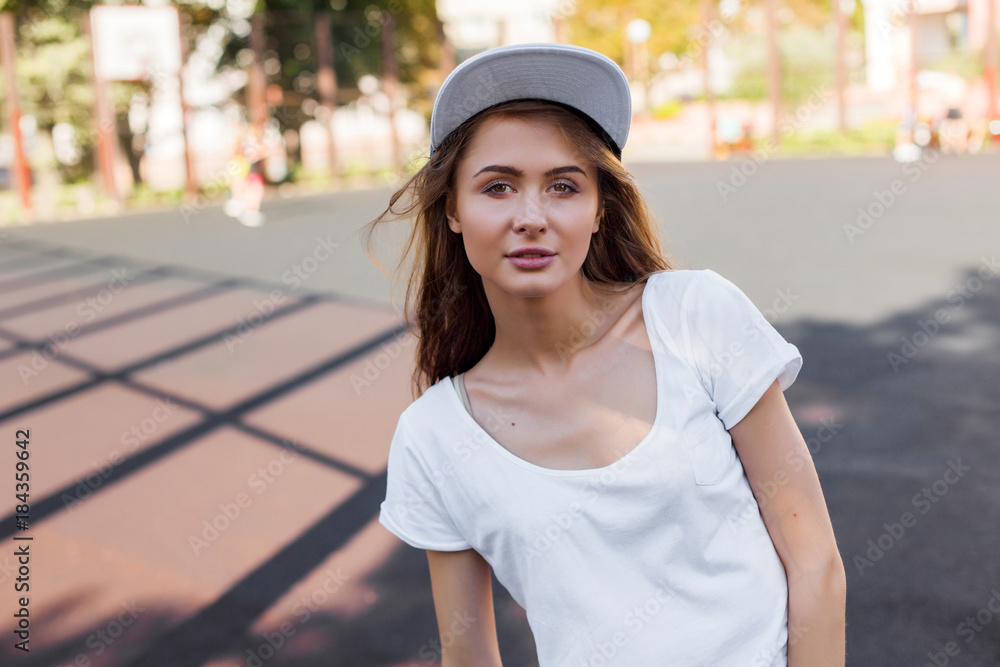 Pretty brunette woman sensual style summer portrait posing outdoor on the street in hat Pretty brunette woman sensual style summer portrait posing outdoor on the street in hat