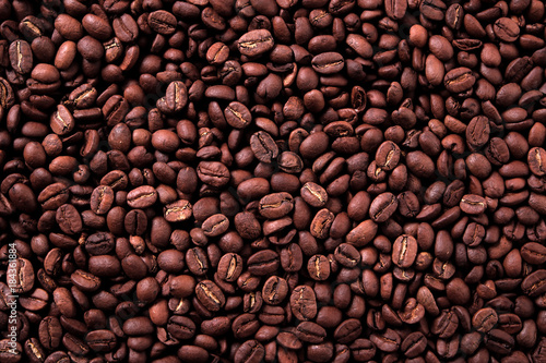 Coffee bean dark roasted scattered background texture photo