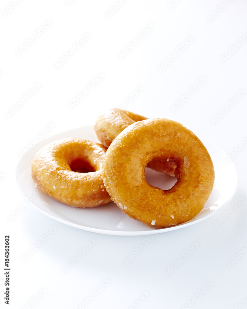 Donut isolated on a white plate Donut isolated on a white plate