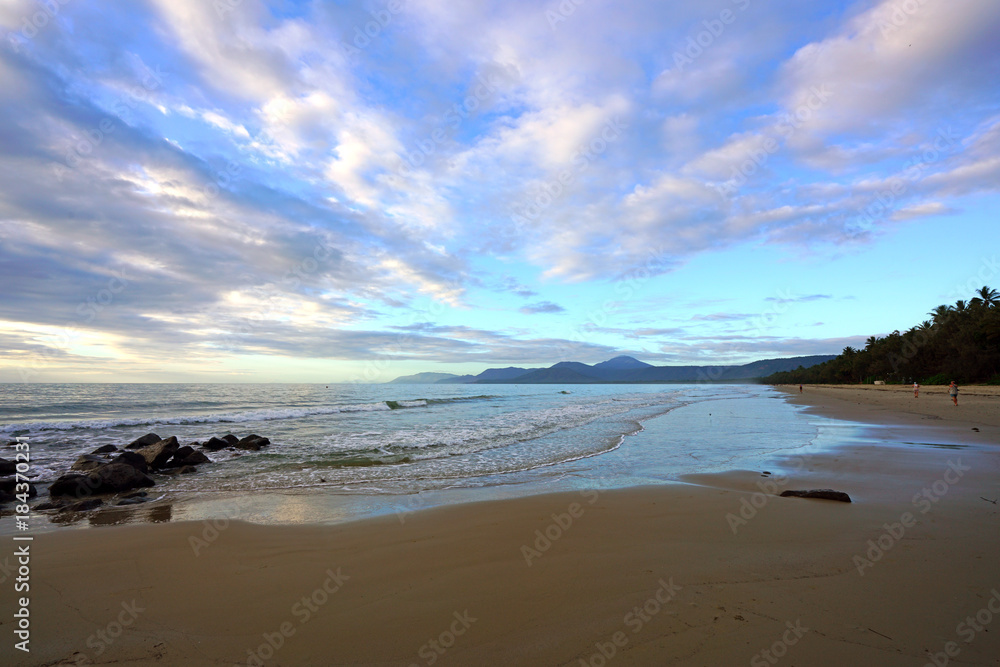 Sunset over the Four Mile Beach overlooking the Coral Sea in Port Douglas, Australia Sunset over the Four Mile Beach overlooking the Coral Sea in Port Douglas, Australia