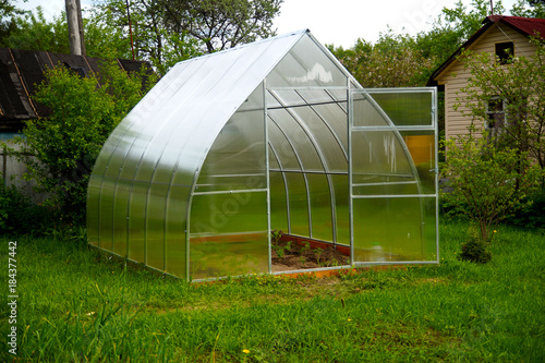 transparent greenhouse in the garden © lexxxx37