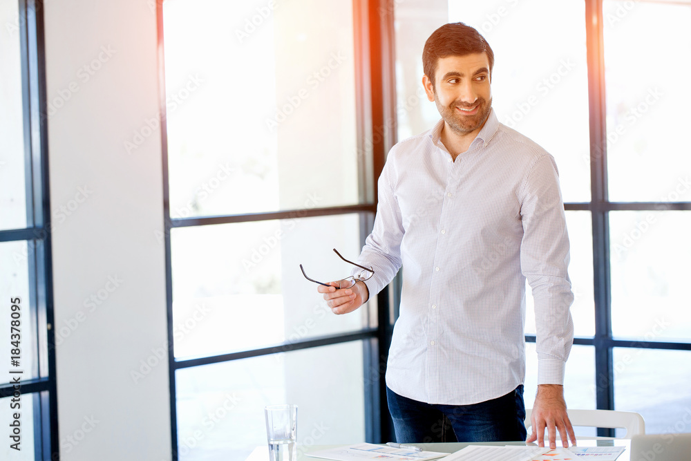 Young caucasian businessman standing in office